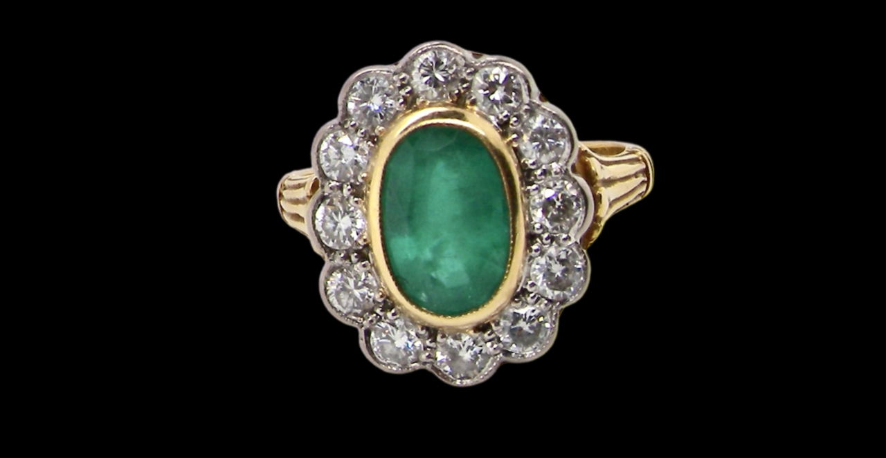 An impressive Emerald and Diamond cluster Ring