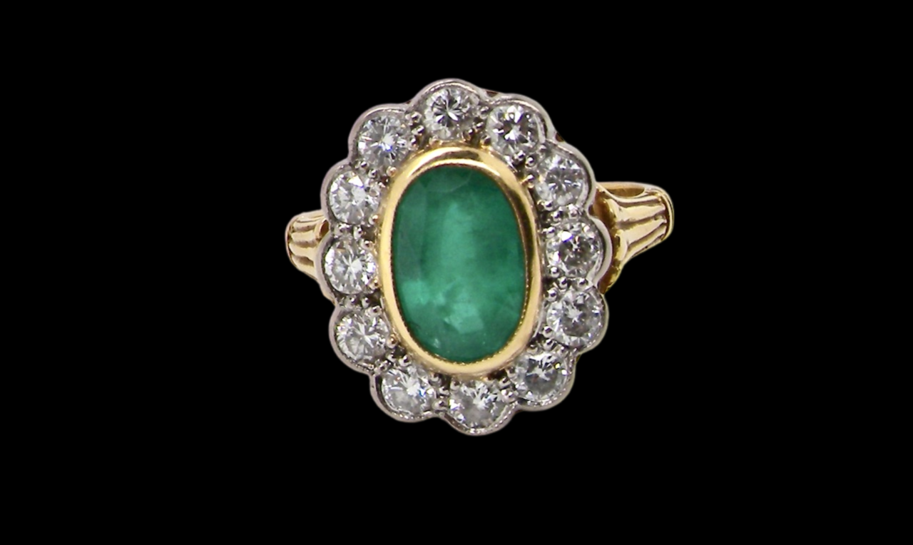 An impressive Emerald and Diamond cluster Ring