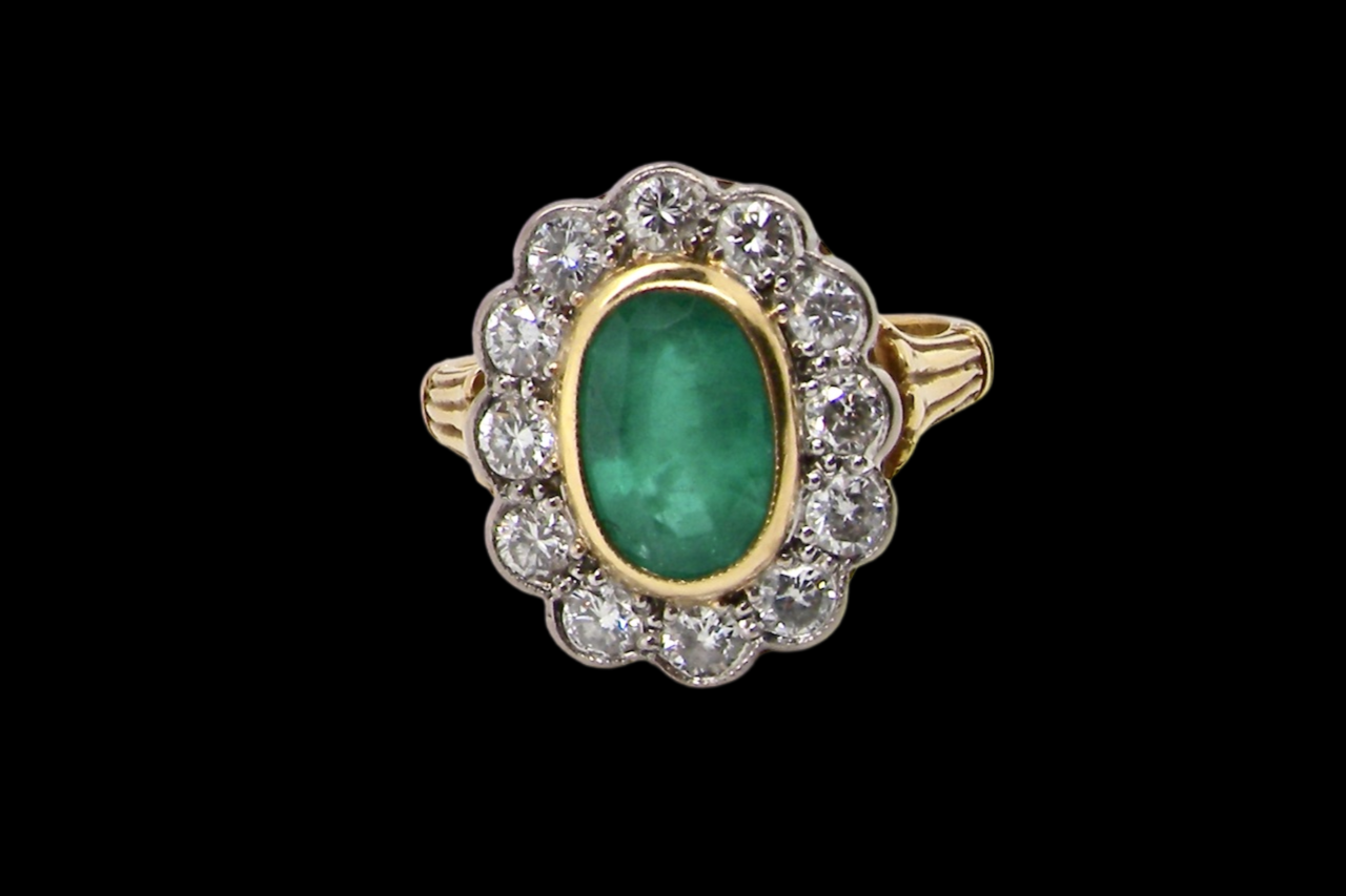 An impressive Emerald and Diamond cluster Ring