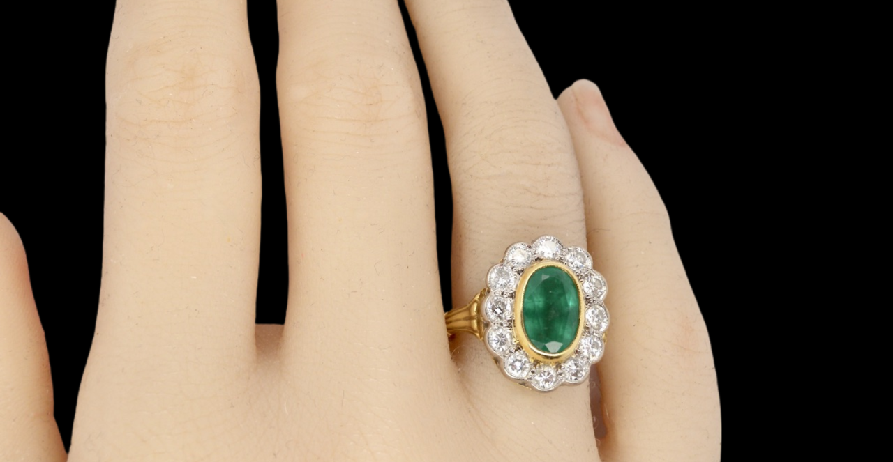An 18 carat gold Emerald and Diamond Ring