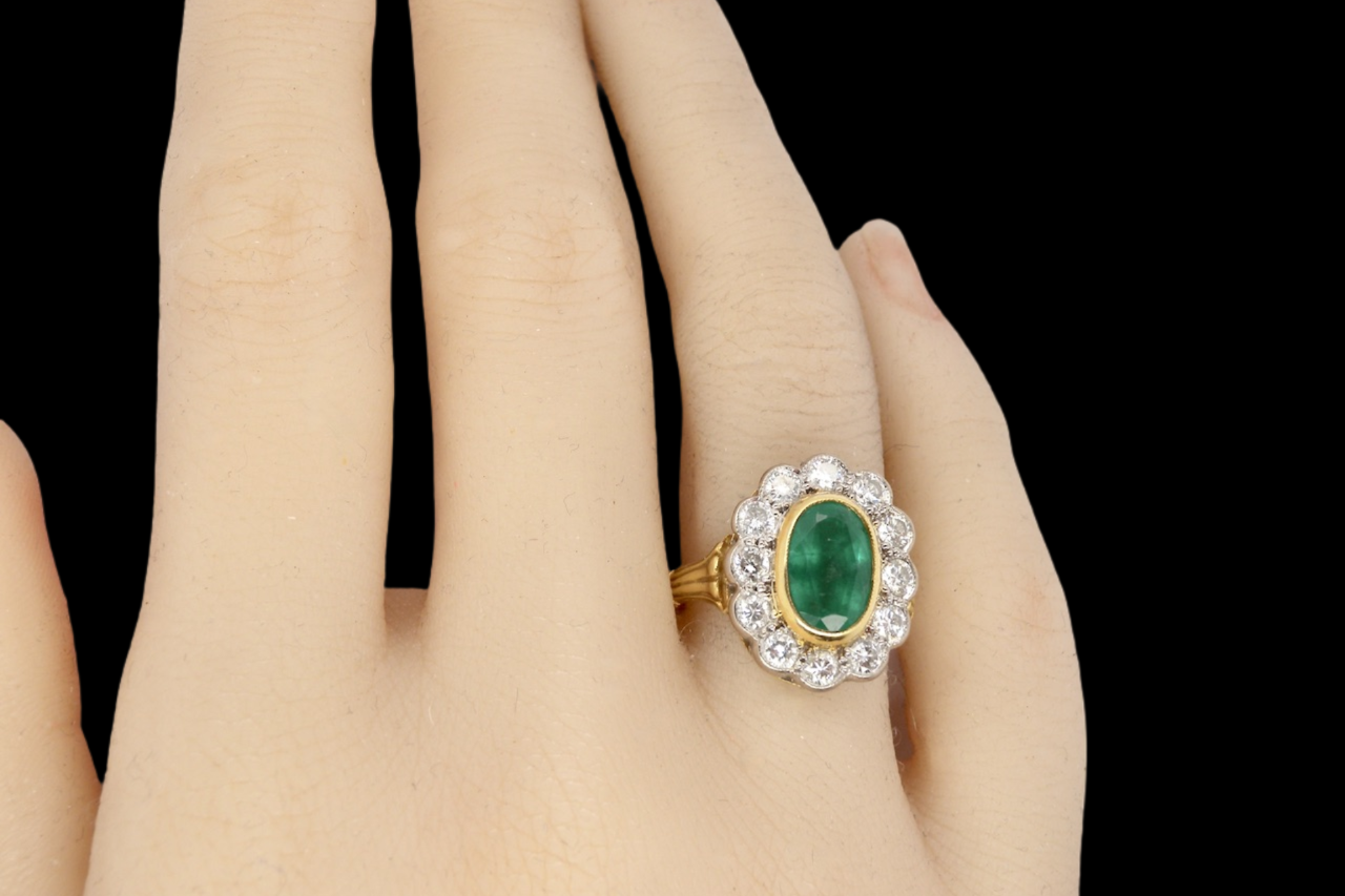 An 18 carat gold Emerald and Diamond Ring