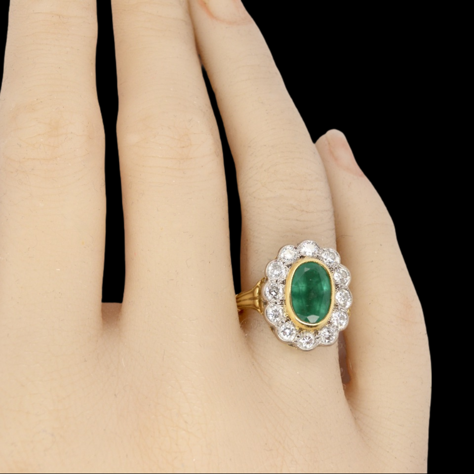 An 18 carat gold Emerald and Diamond Ring