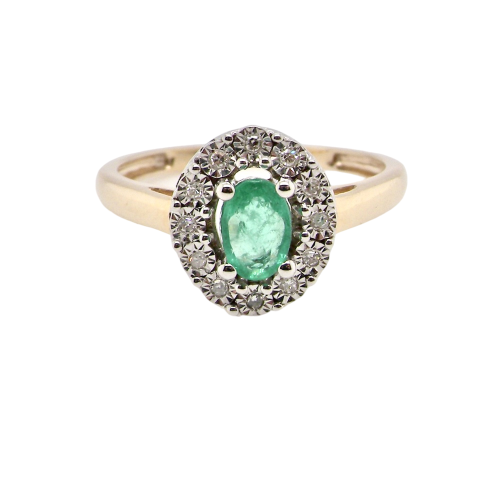 An emerald and diamond cluster ring