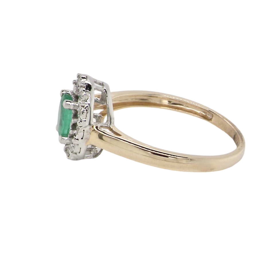 A side view emerald and diamond cluster ring