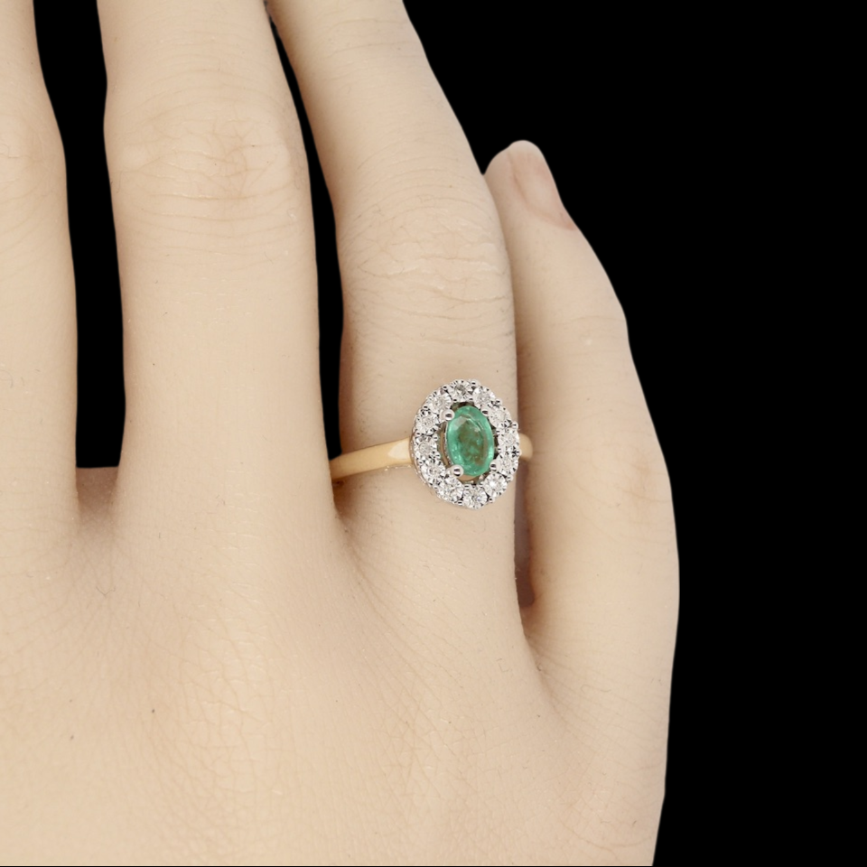 An emerald and diamond ring