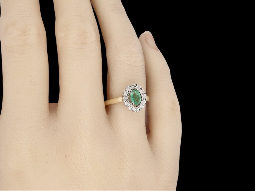 An emerald and diamond  ring