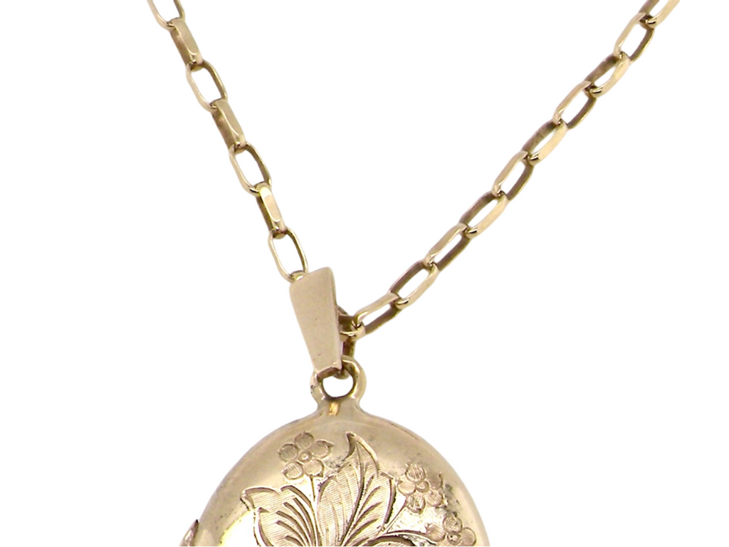 An oval gold locket chain