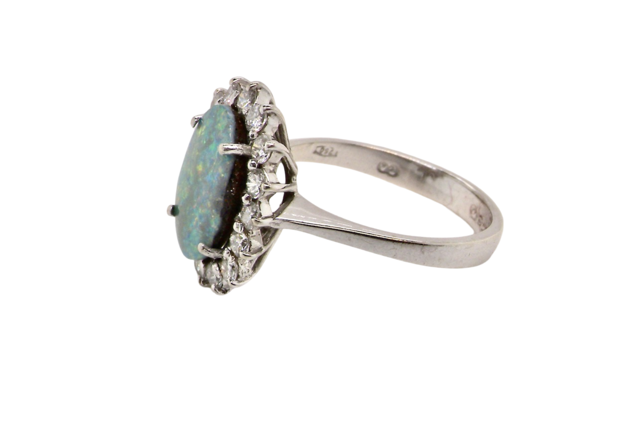 An opal and diamond cluster ring side view