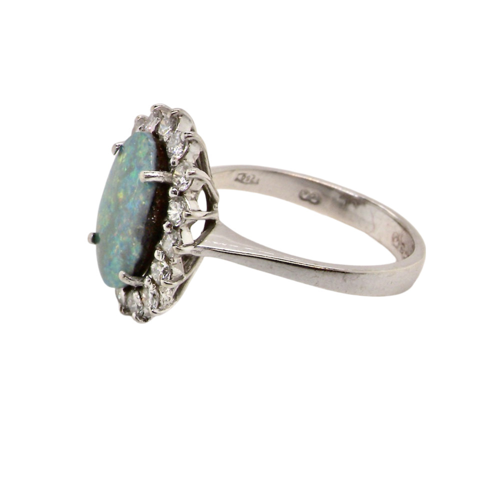 An opal and diamond cluster ring side view