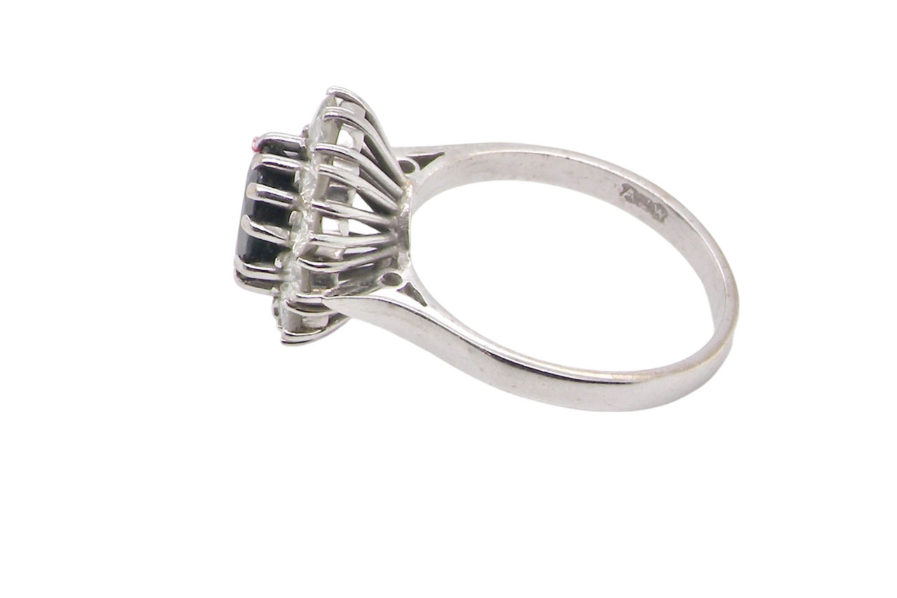 A sapphire and diamond cluster ring side view