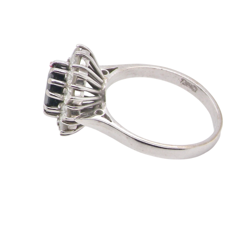 A sapphire and diamond cluster ring side view