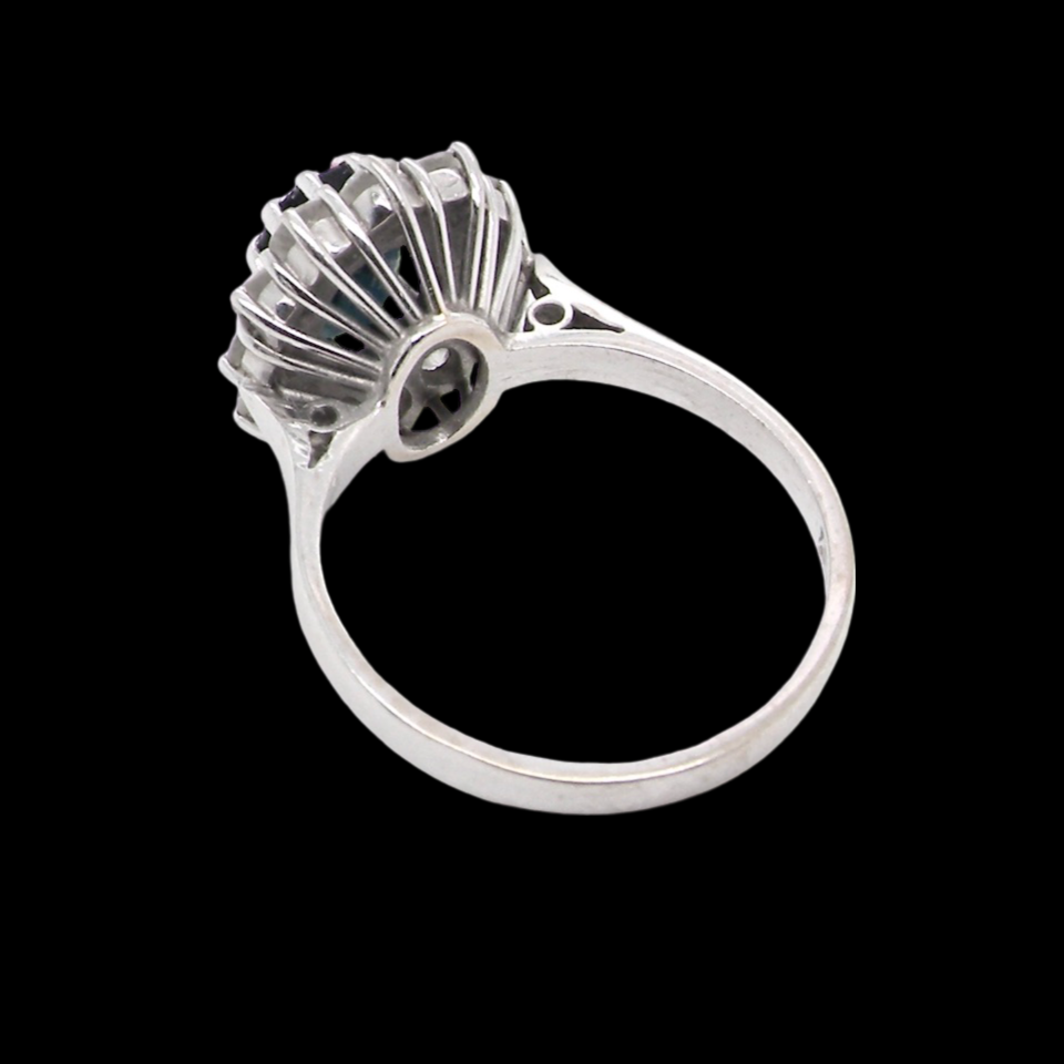 A sapphire and diamond cluster ring rear view