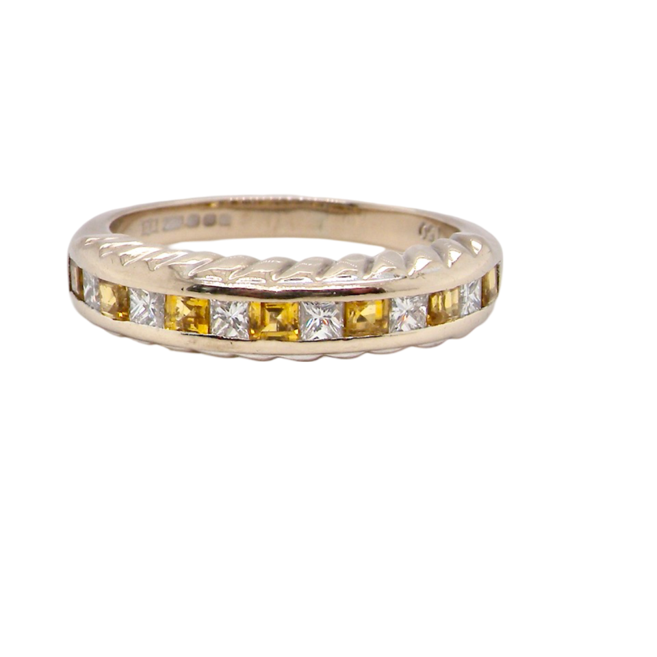 A yellow sapphire and diamond eternity ring