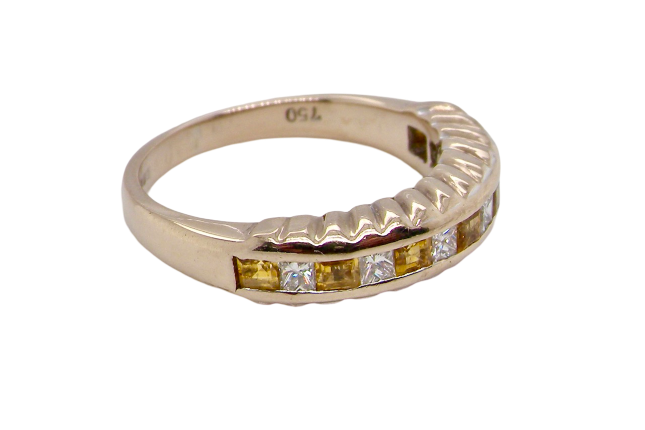 A yellow sapphire and diamond ring