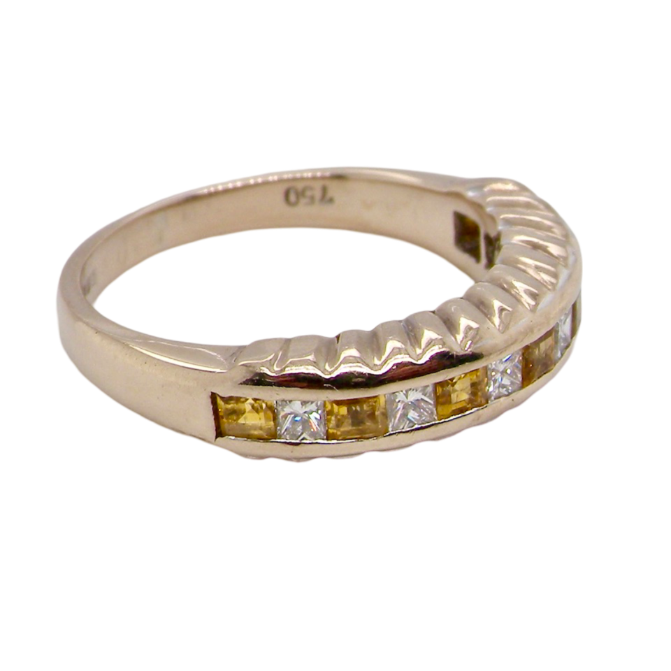 A yellow sapphire and diamond ring