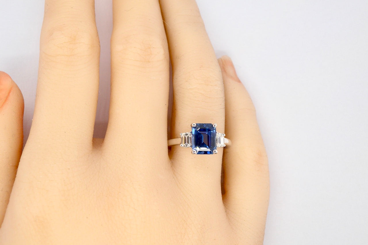 A fine three stone Sapphire and Diamond Ring finger view