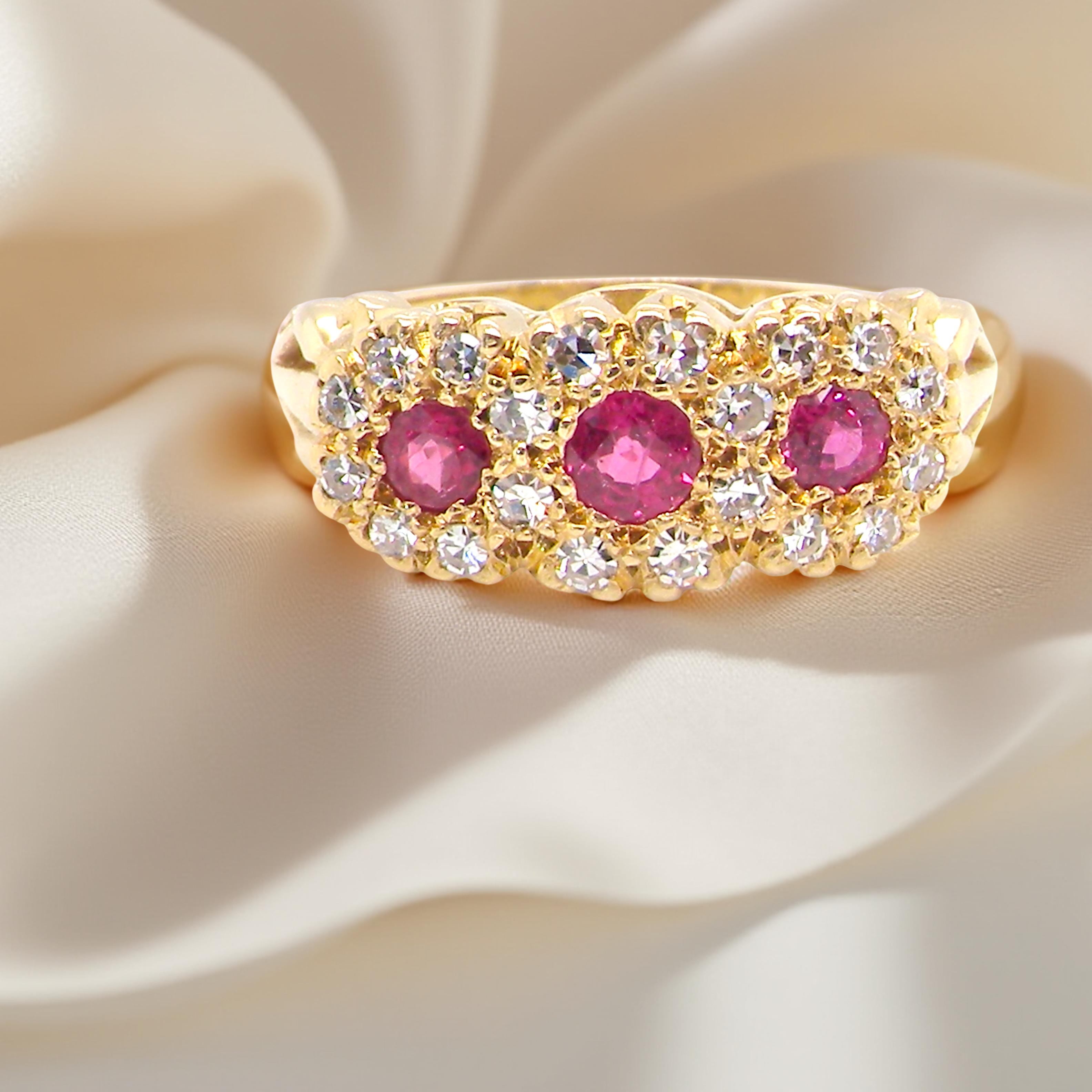 Gold ring with pink gemstones on a beige fabric background