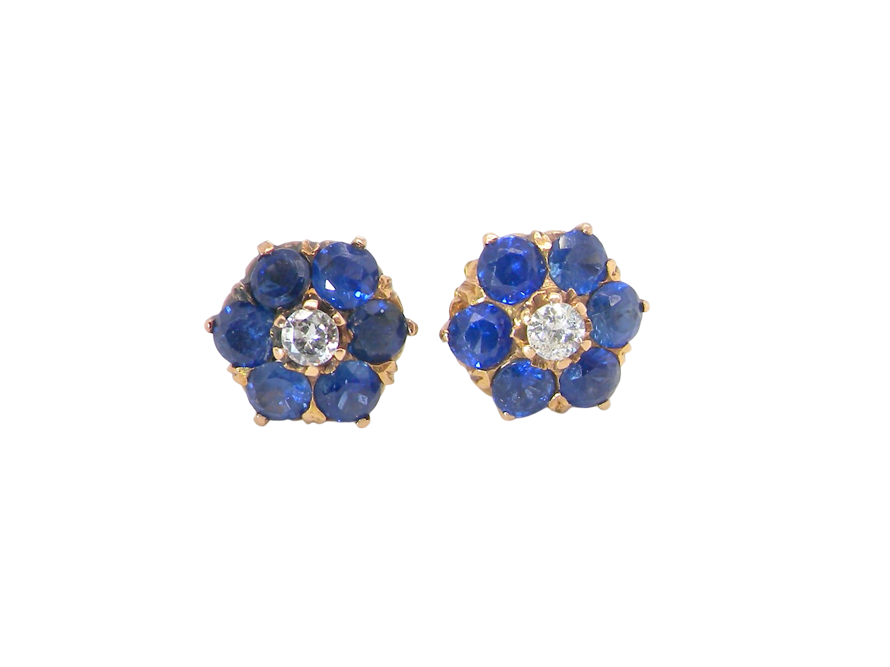 Pair of earrings with blue gemstones and a central diamond on a white background