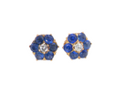 Pair of earrings with blue gemstones and a central diamond on a white background