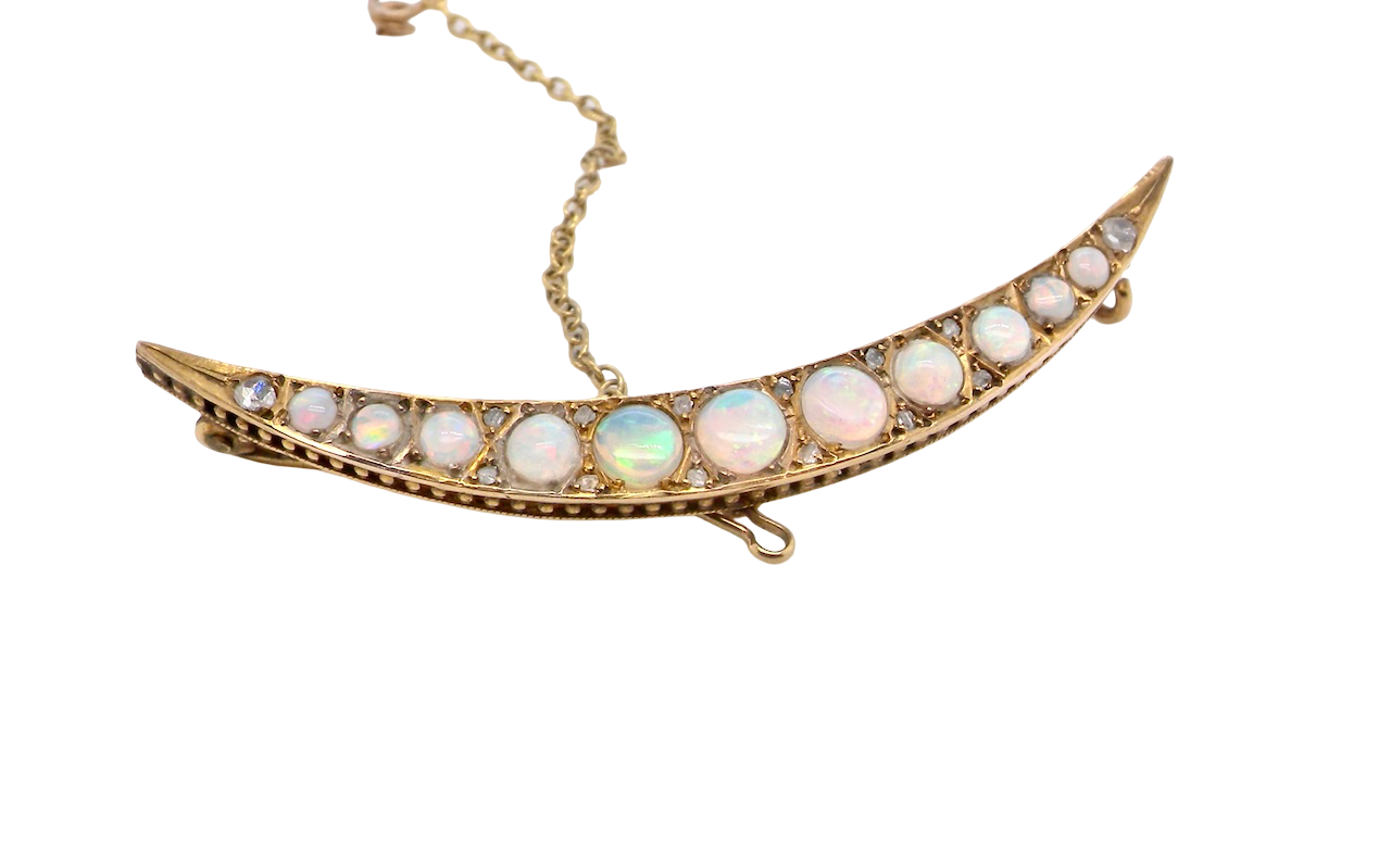 An Edwardian opal crescent shaped brooch