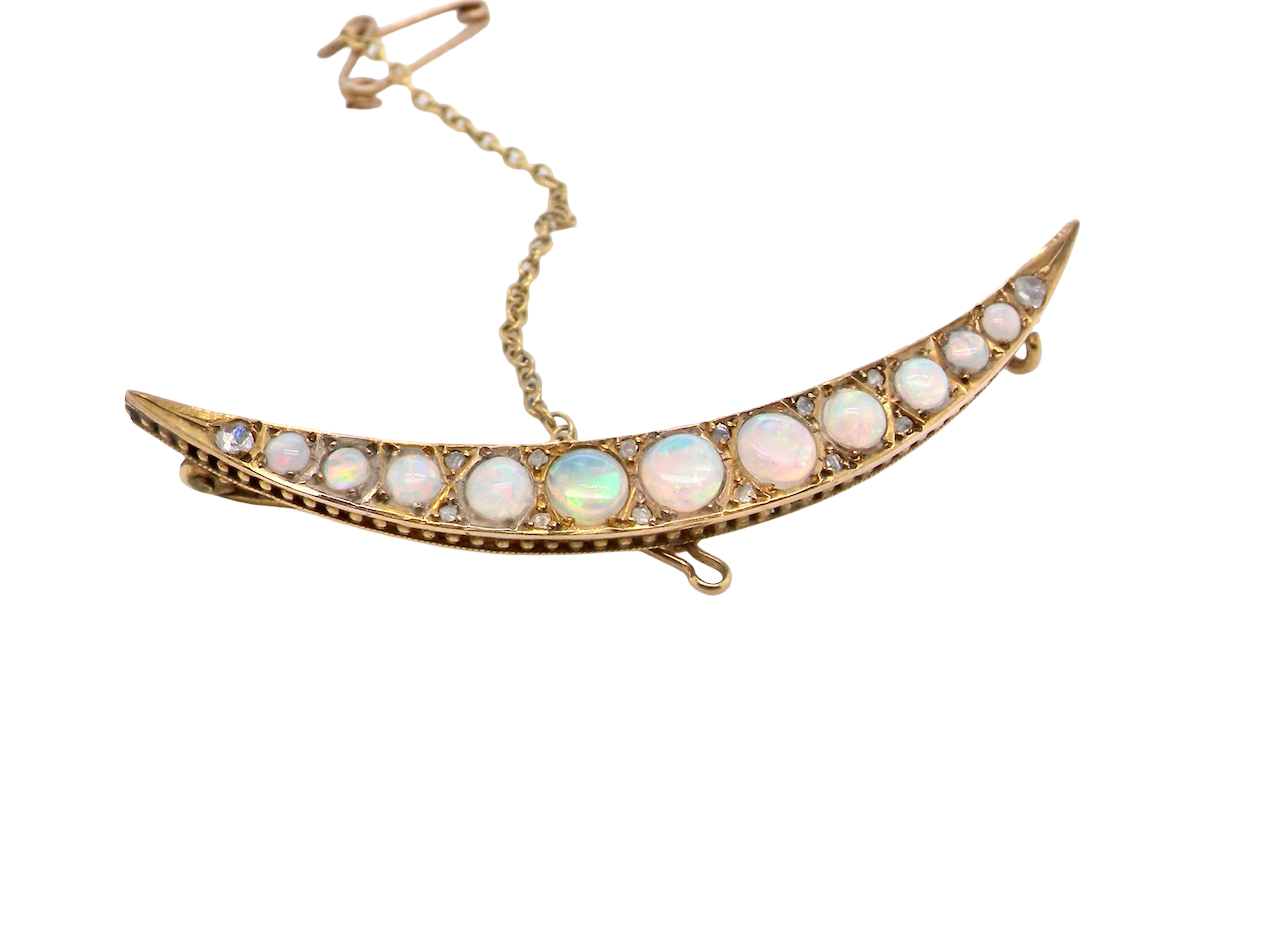 An Edwardian opal crescent shaped brooch