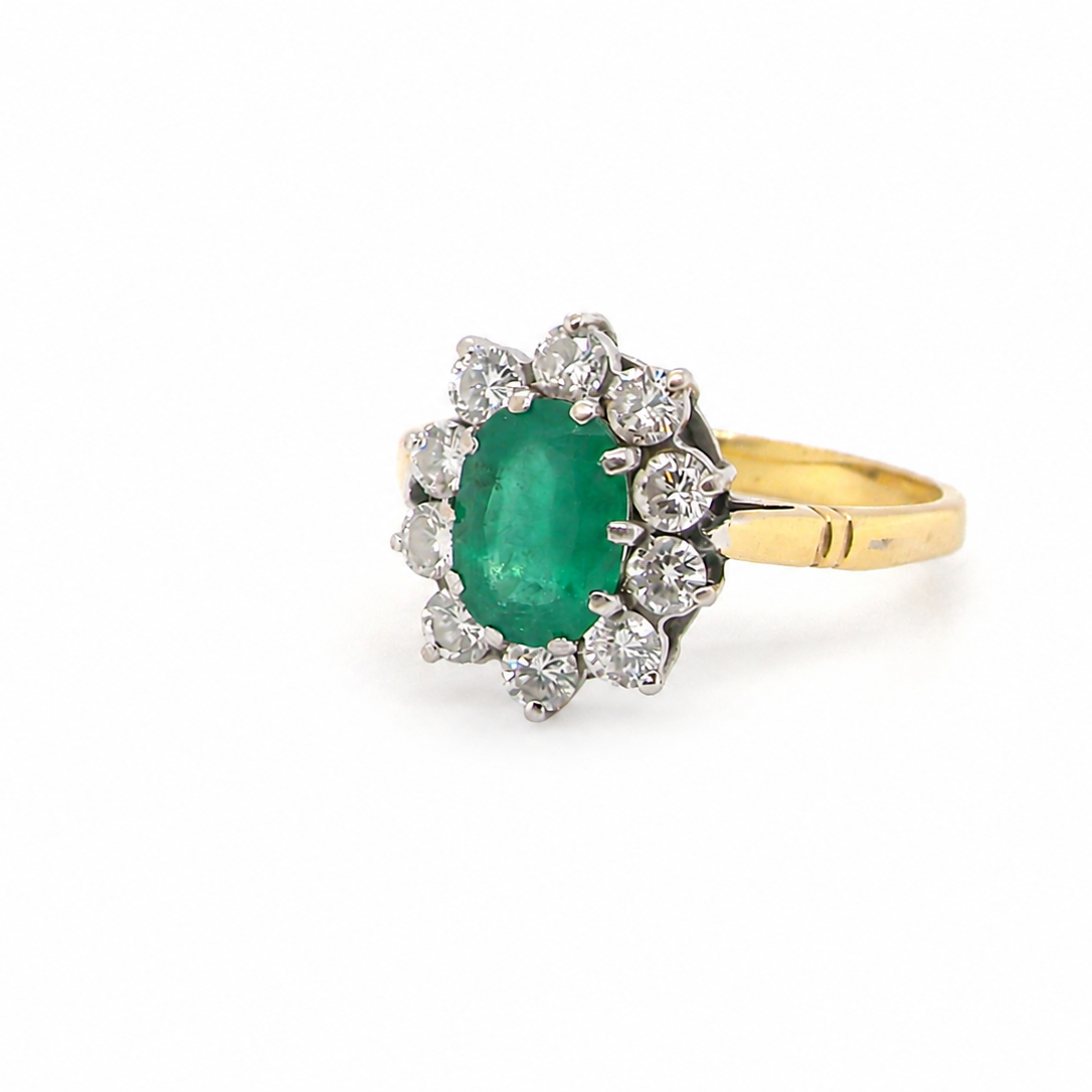 Features an oval cut emerald centre stone, vibrant green hues, measures 9x6mm(est 1.75 carats) . Complimented by an outer halo of ten 2.7mm brilliant cut white diamonds (