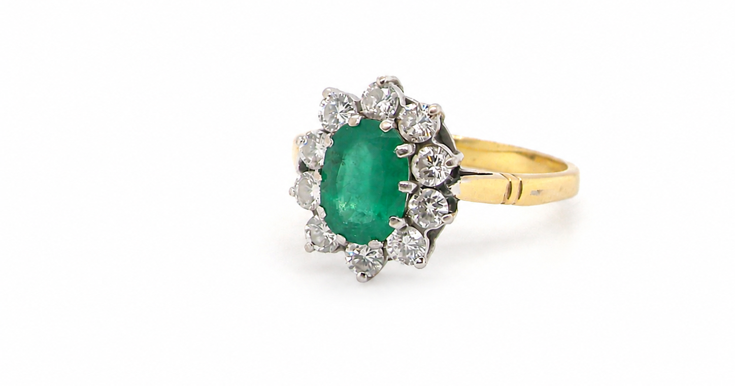 Features an oval cut emerald centre stone, vibrant green hues, measures 9x6mm(est 1.75 carats) . Complimented by an outer halo of ten 2.7mm brilliant cut white diamonds (