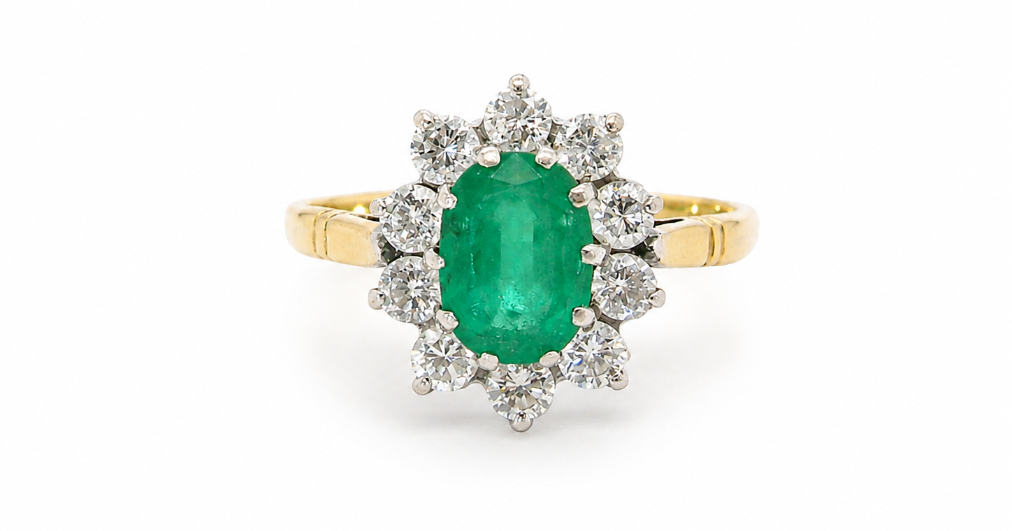 Features an oval cut emerald centre stone, vibrant green hues, measures 9x6mm(est 1.75 carats) . Complimented by an outer halo of ten 2.7mm brilliant cut white diamonds (est total 0.60 carats)
