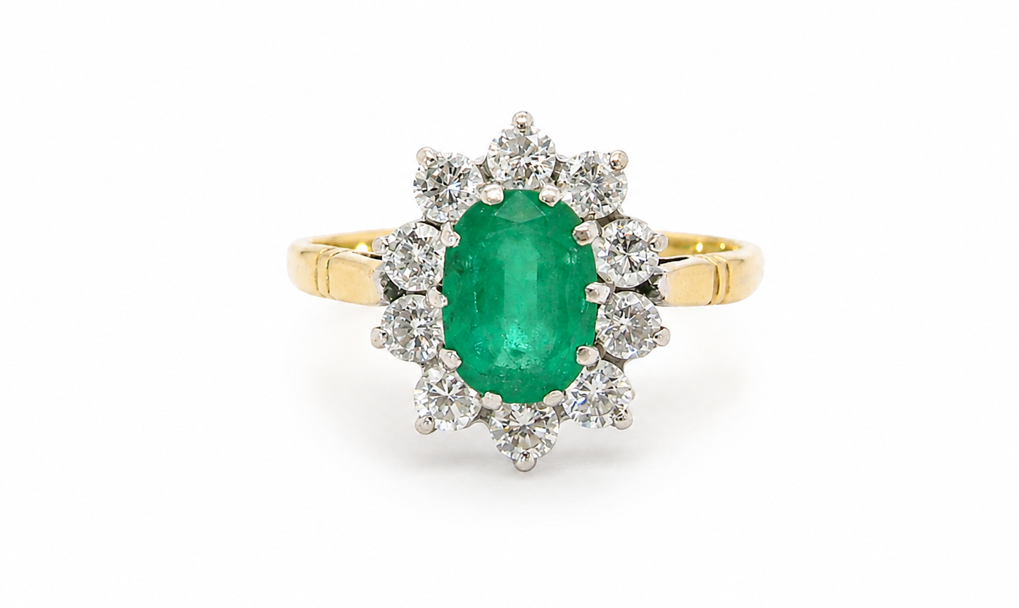 Features an oval cut emerald centre stone, vibrant green hues, measures 9x6mm(est 1.75 carats) . Complimented by an outer halo of ten 2.7mm brilliant cut white diamonds (est total 0.60 carats)