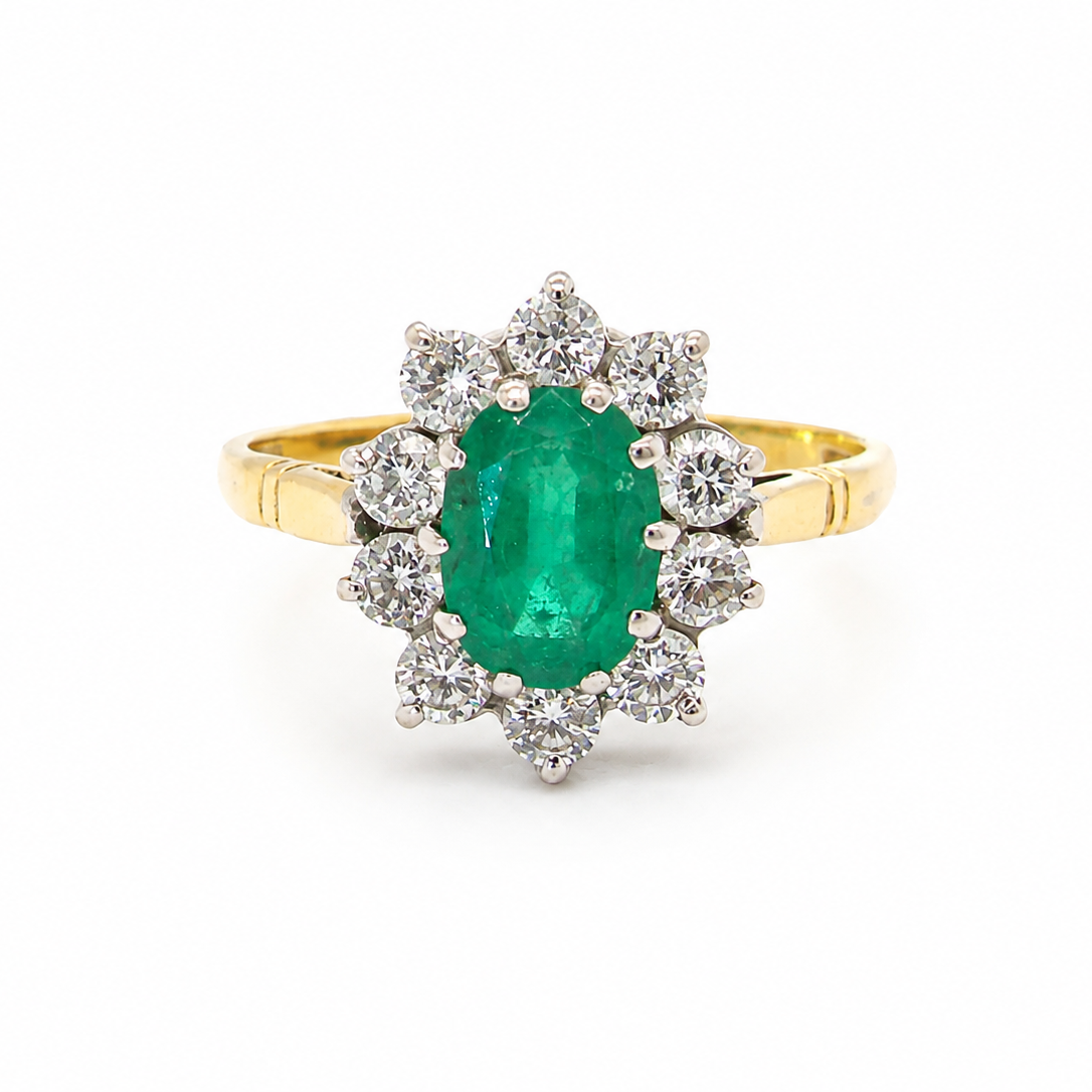Features an oval cut emerald centre stone, vibrant green hues, measures 9x6mm(est 1.75 carats) . Complimented by an outer halo of ten 2.7mm brilliant cut white diamonds (est total 0.60 carats) colour i-j, clarity S.