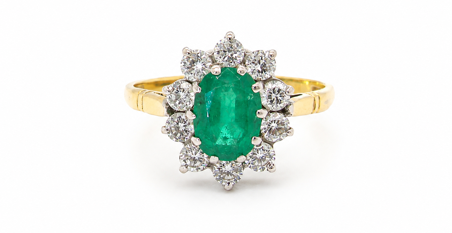 Features an oval cut emerald centre stone, vibrant green hues, measures 9x6mm(est 1.75 carats) . Complimented by an outer halo of ten 2.7mm brilliant cut white diamonds (est total 0.60 carats) colour i-j, clarity S.