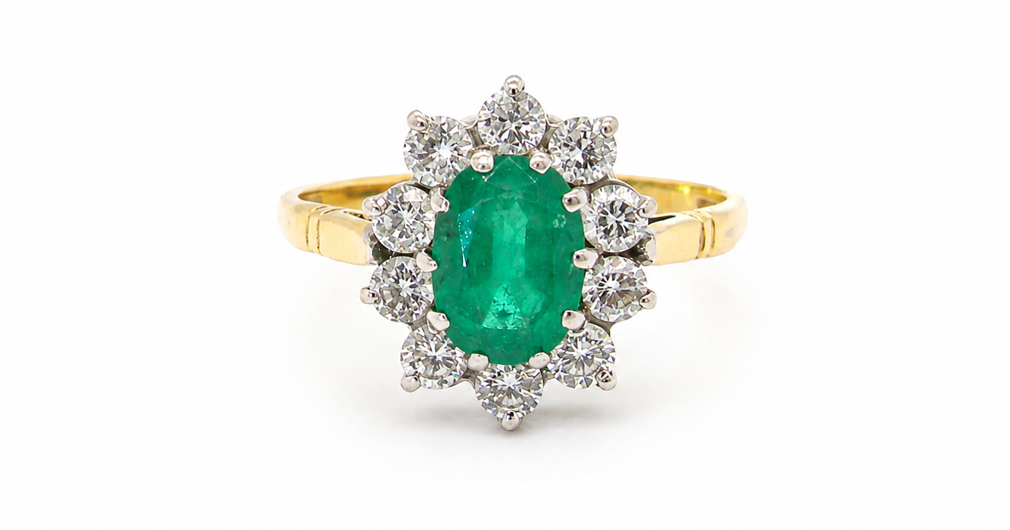 Features an oval cut emerald centre stone, vibrant green hues, measures 9x6mm(est 1.75 carats) . Complimented by an outer halo of ten 2.7mm brilliant cut white diamonds (est total 0.60 carats) colour i-j, clarity S.