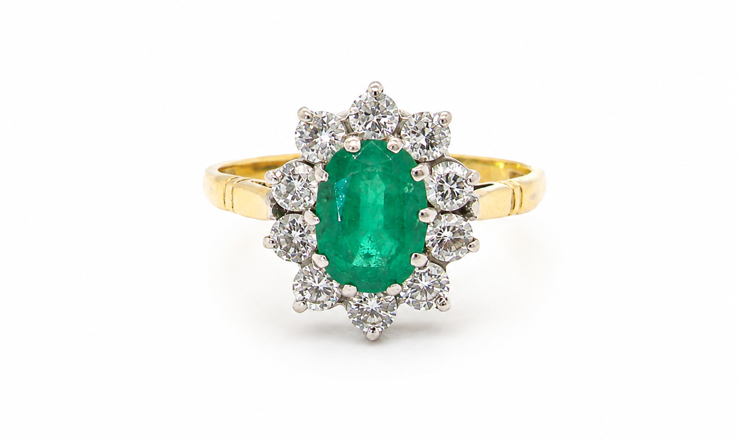 Features an oval cut emerald centre stone, vibrant green hues, measures 9x6mm(est 1.75 carats) . Complimented by an outer halo of ten 2.7mm brilliant cut white diamonds (est total 0.60 carats) colour i-j, clarity S.