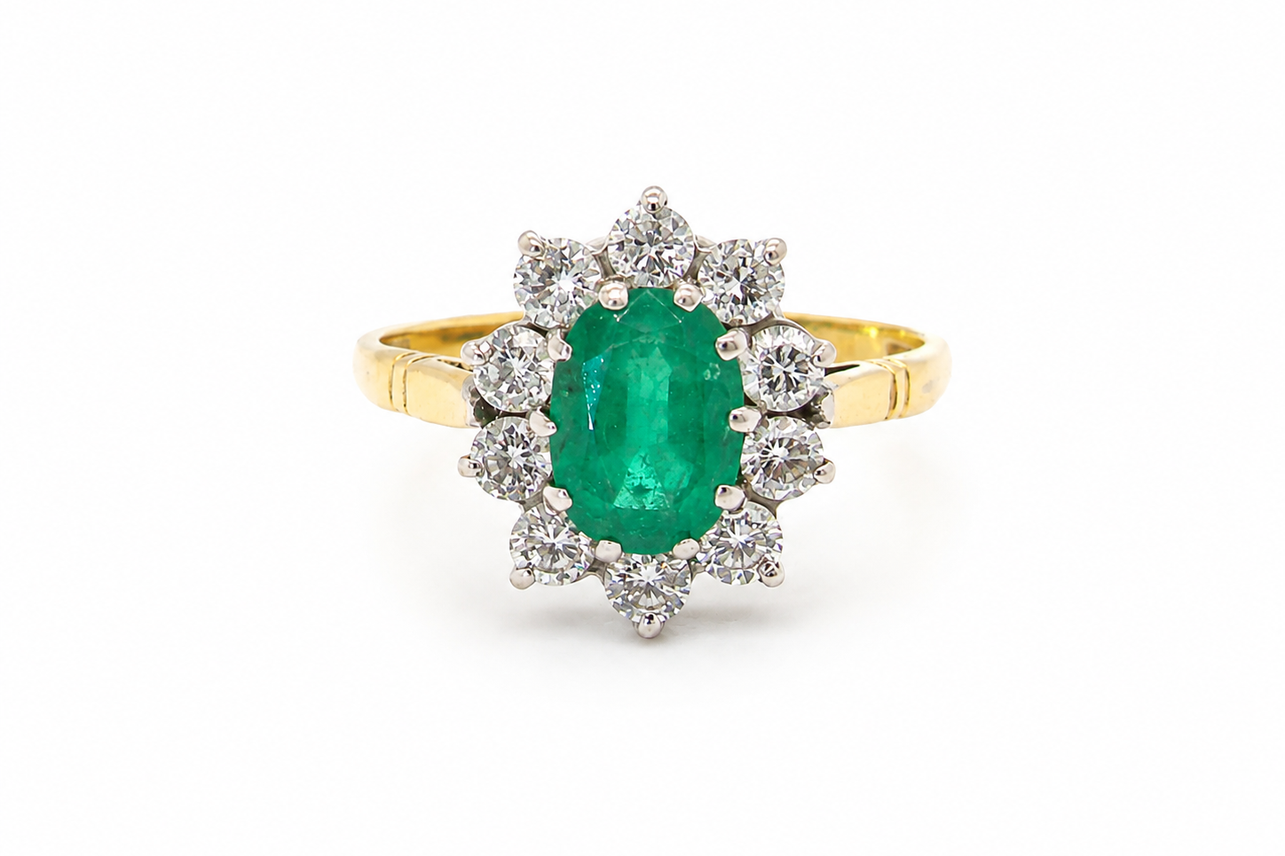 Features an oval cut emerald centre stone, vibrant green hues, measures 9x6mm(est 1.75 carats) . Complimented by an outer halo of ten 2.7mm brilliant cut white diamonds (est total 0.60 carats) colour i-j, clarity S.