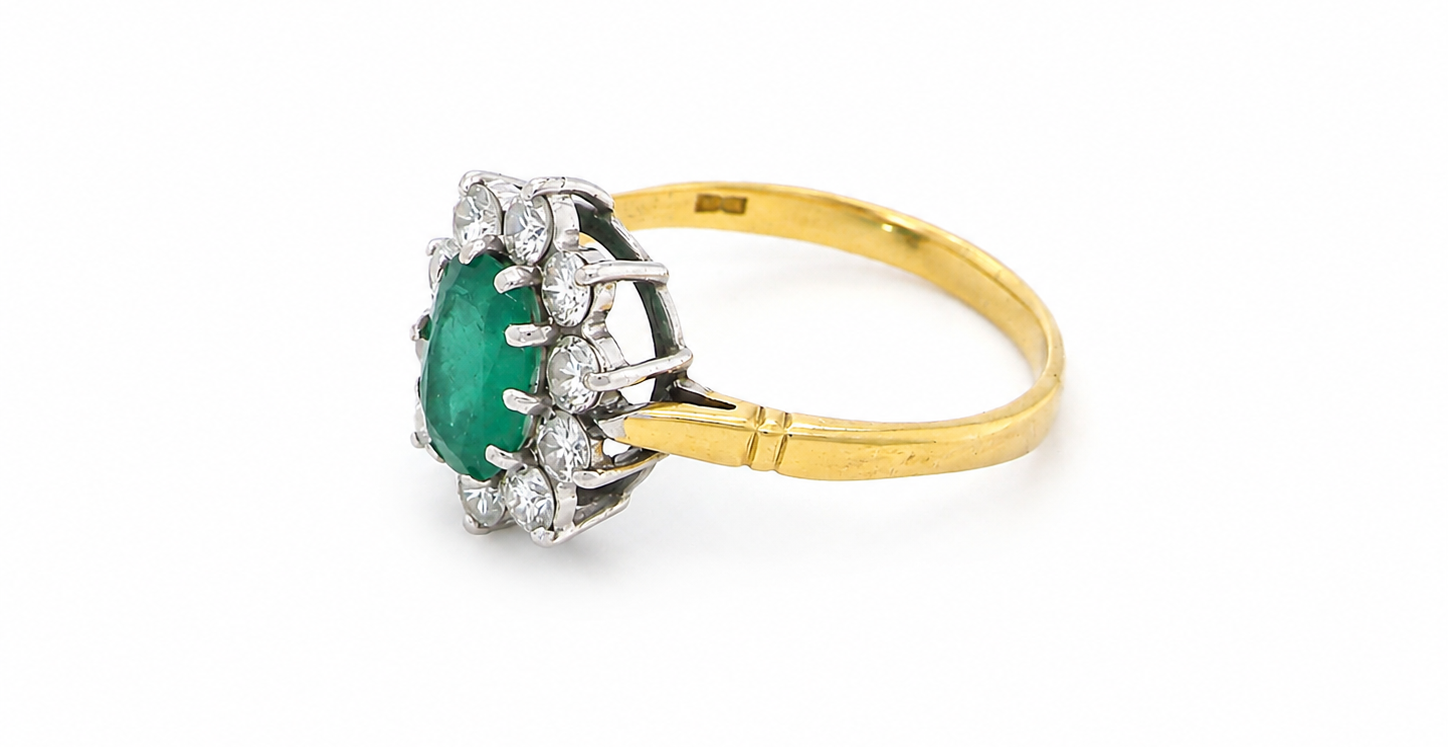 Features an oval cut emerald centre stone, vibrant green hues, measures 9x6mm(est 1.75 carats) . Complimented by an outer halo of ten 2.7mm brilliant cut white diamonds (est total 0.60 carats) colour i-j, clarity S.
side