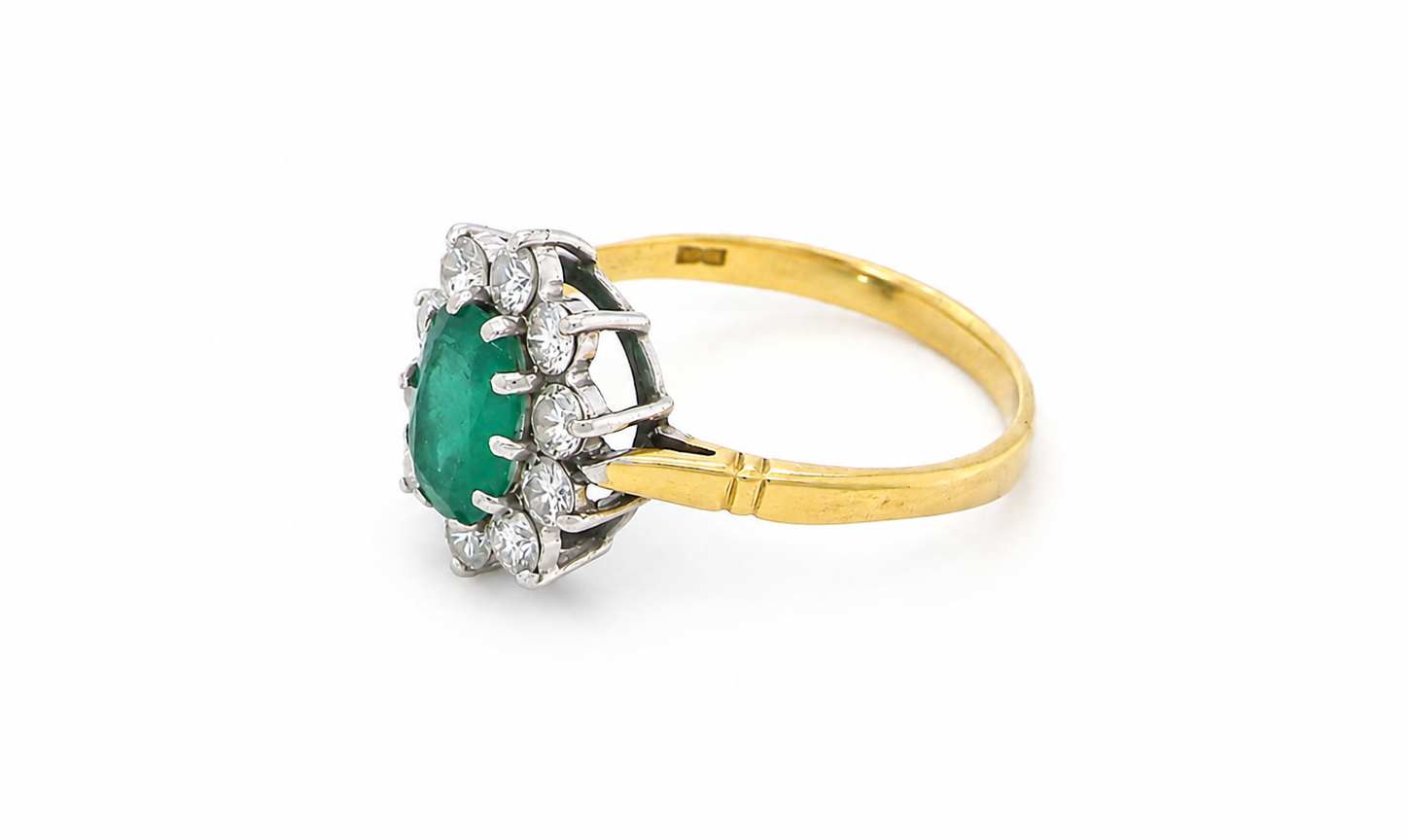 Features an oval cut emerald centre stone, vibrant green hues, measures 9x6mm(est 1.75 carats) . Complimented by an outer halo of ten 2.7mm brilliant cut white diamonds (est total 0.60 carats) colour i-j, clarity S.
side
