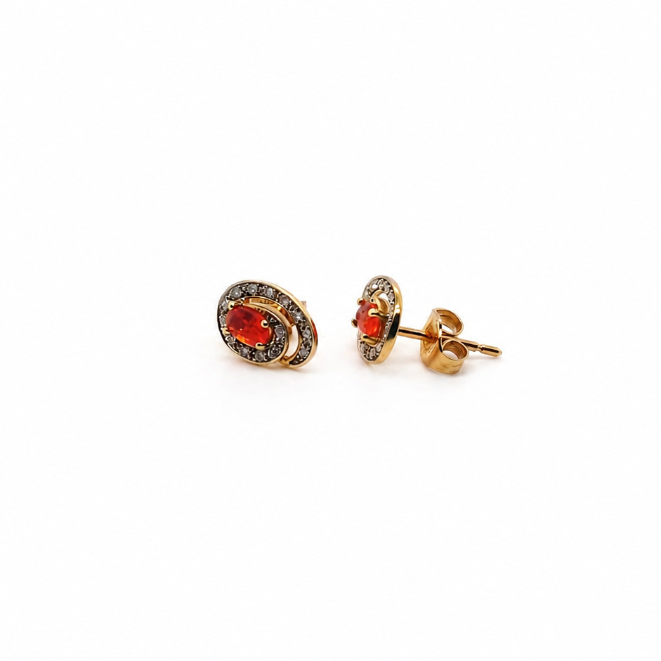 Pair of earrings with fire opals on a white background side view