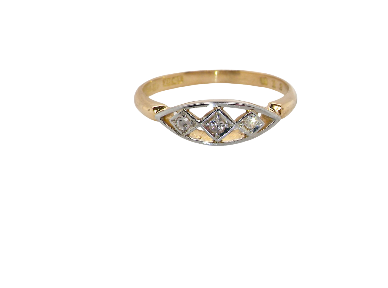 Gold ring with diamond accents on a white background