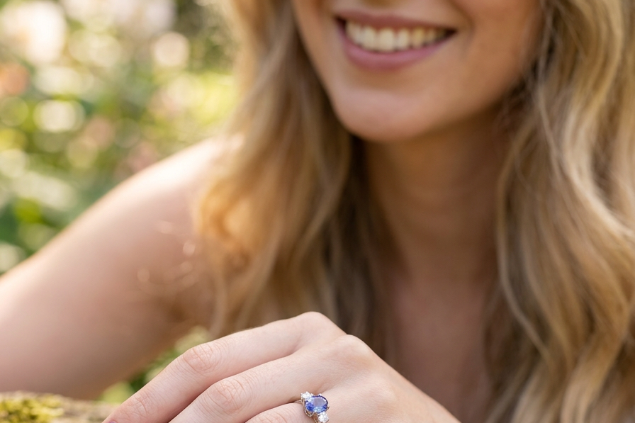 model A three stone ring that features an impressive tanzanite centre stone that measures 10x8mm (3.21 carats confirmed) AAA colour. 