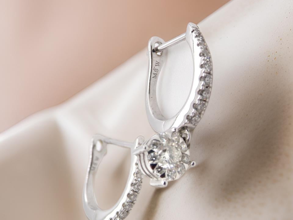 A pair of diamond hoop and drop earrings