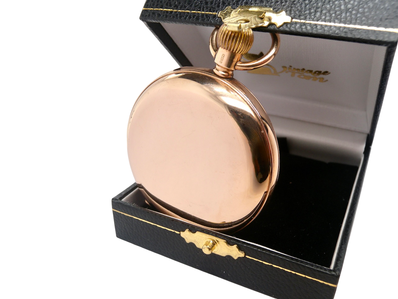 Rose gold pocket watch with open face on a black background case