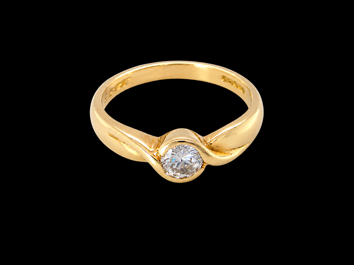 A yellow gold ring with a twisted band and a single round-cut clear gemstone, shown against a solid black background.