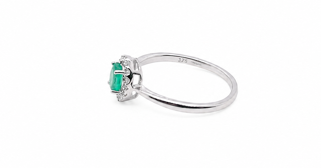 white gold ring with a green gemstone on a white background side image