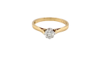 Gold ring with a diamond on a white background