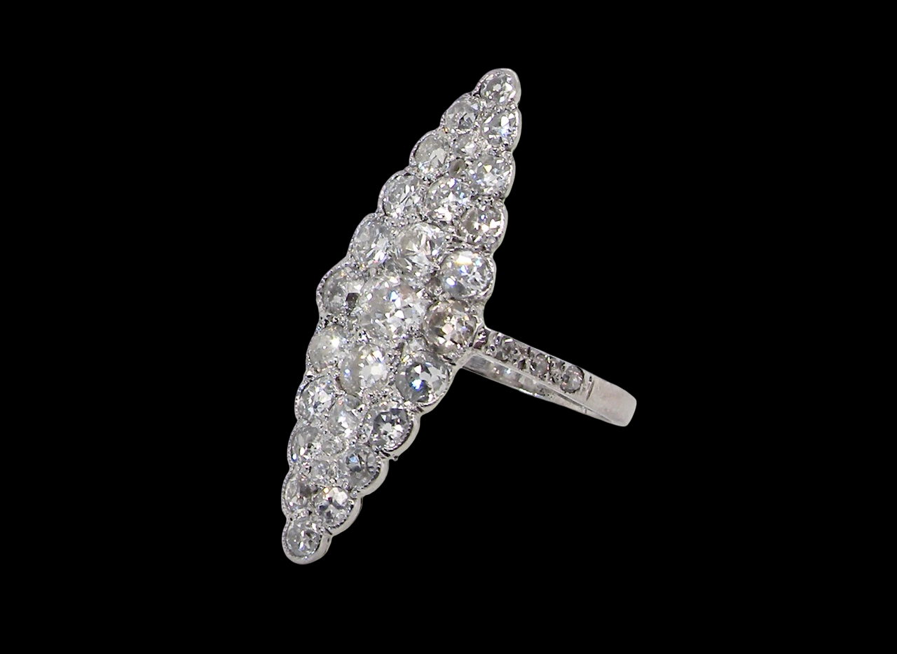 This is a striking marquise-shaped diamond cluster ring a very classic, vintage-inspired look.