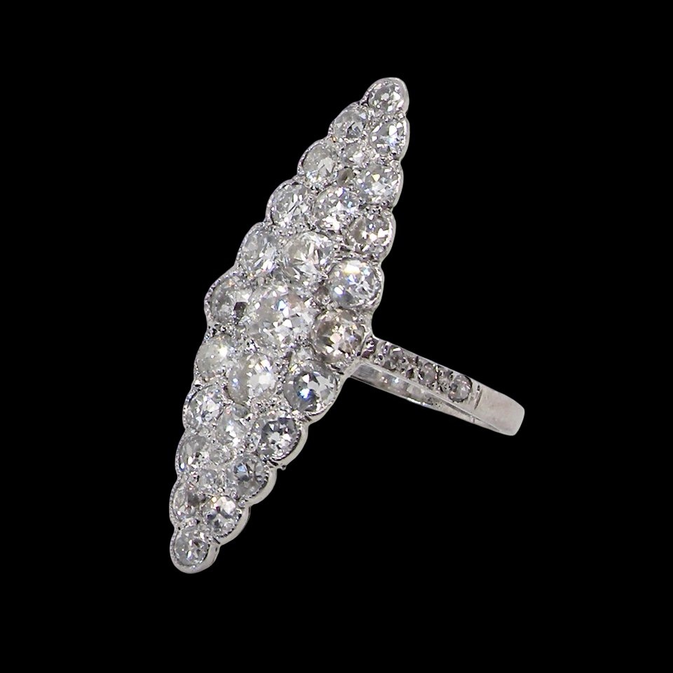 This is a striking marquise-shaped diamond cluster ring a very classic, vintage-inspired look.