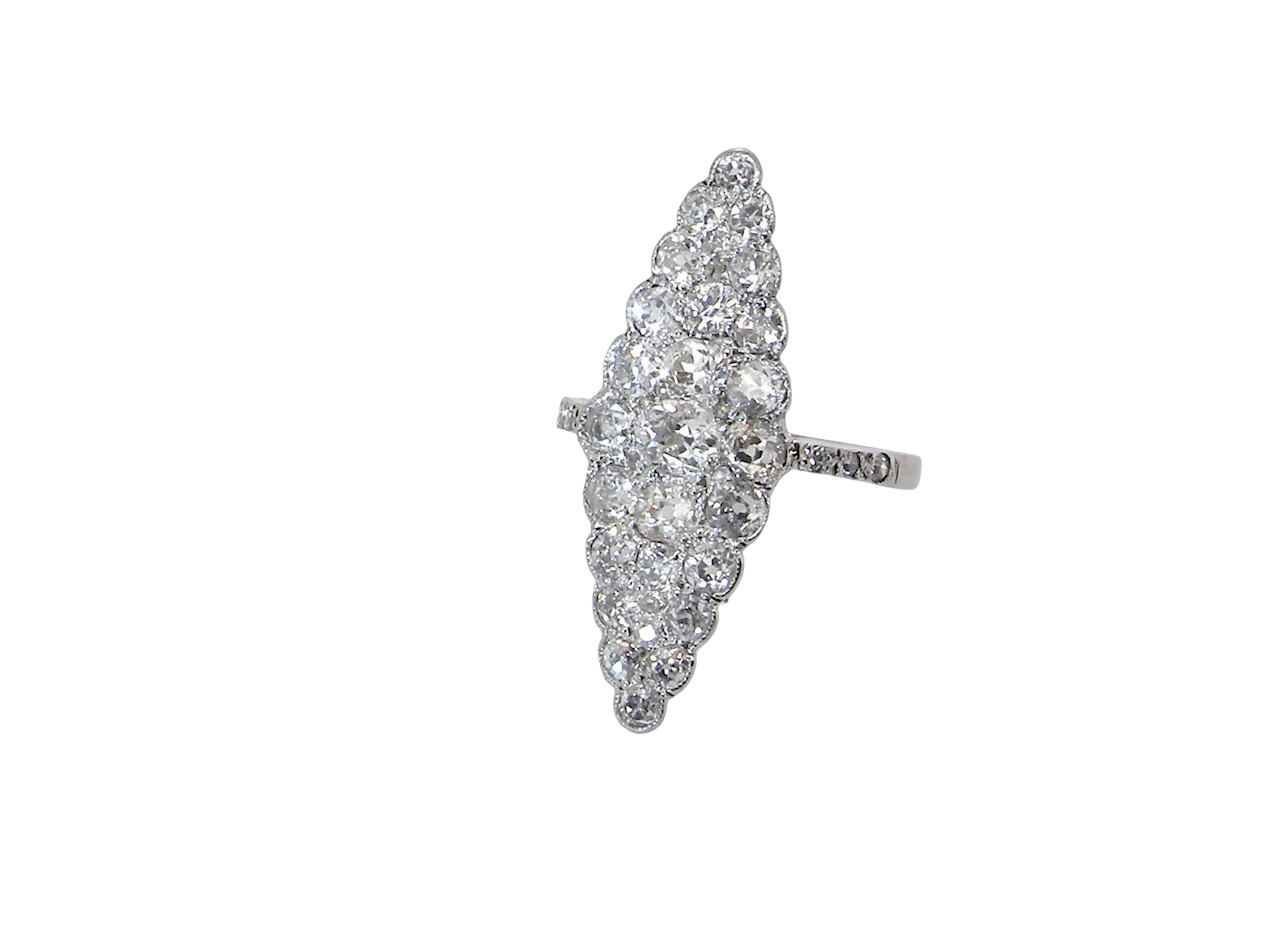 This is a striking marquise-shaped diamond cluster ring with a very classic, vintage-inspired look.