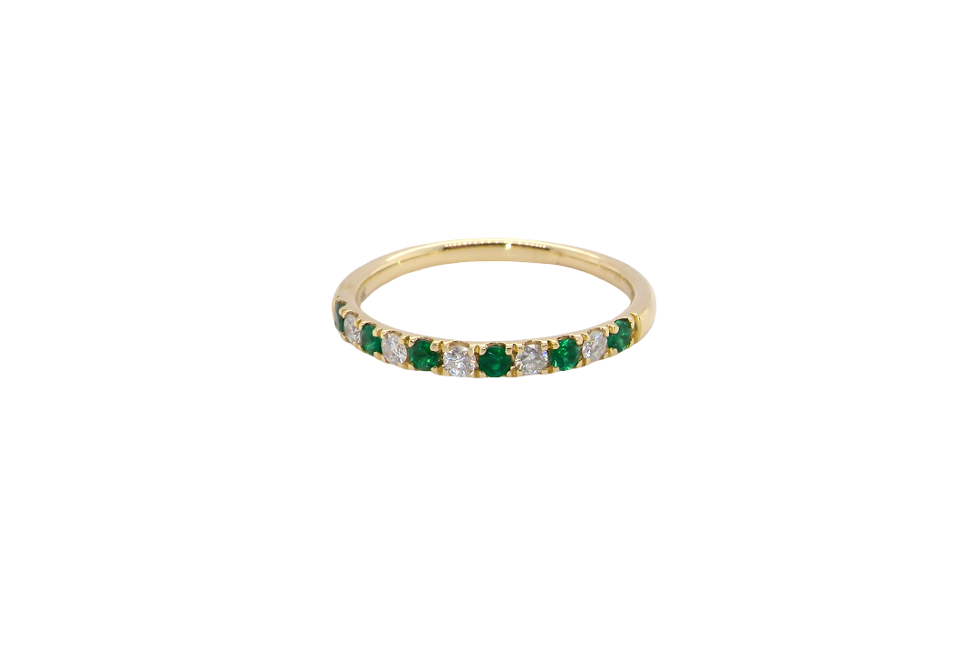 This ring is set with six bright green emeralds, each 2mm, (est 0.25 carats) and five 2mm brilliant cut white diamonds.