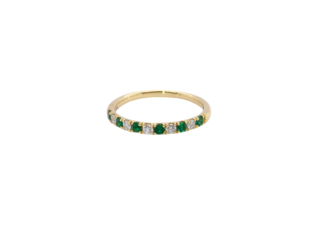 This ring is set with six bright green emeralds, each 2mm, (est 0.25 carats) and five 2mm brilliant cut white diamonds.