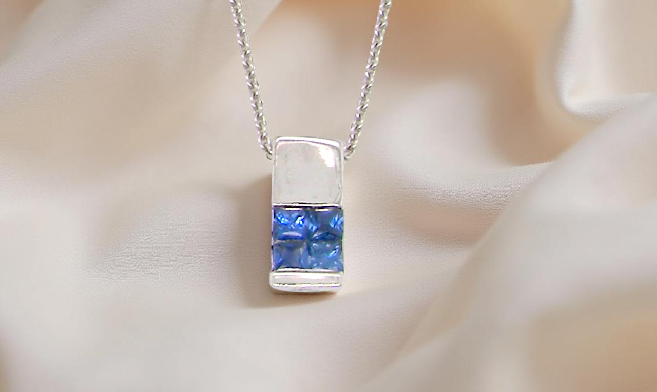 An 18 carat White Gold* Pendant with Sapphires